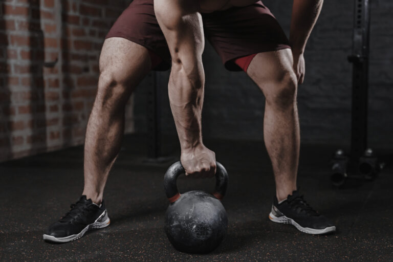Crossfit athlete exercising with a kettlebell at the gym